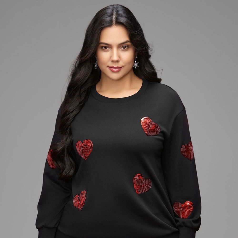 New with tags Black Sweater with red sequins hearts. Very beautiful! BloomChic